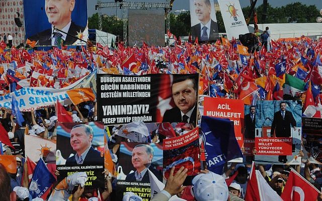 Supporters of Turkish Prime Minister Recep Tayyip Erdogan wave his posters before he arrives to address a party rally in Istanbul on Sunday, June 16, 2013. The banner at the center reads: 'We are with you.' (photo credit: Burhan Ozbilici/AP) Supporters of Turkish Prime Minister Recep Tayyip Erdogan wave his posters before he arrives to address a party rally in Istanbul on Sunday, June 16, 2013. The banner at the center reads: 'We are with you.' (photo credit: Burhan Ozbilici/AP)