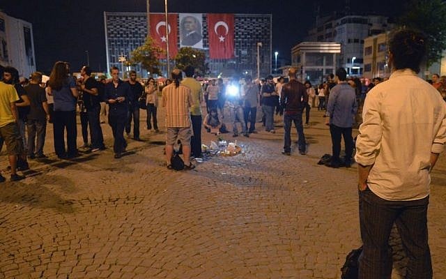 Erdem Gunduz, right, stands silently on Taksim Square in Istanbul, Turkey, early Tuesday, June 18, 2013. (Photo credit: AP) Erdem Gunduz, right, stands silently on Taksim Square in Istanbul, Turkey, early Tuesday, June 18, 2013. (Photo credit: AP)