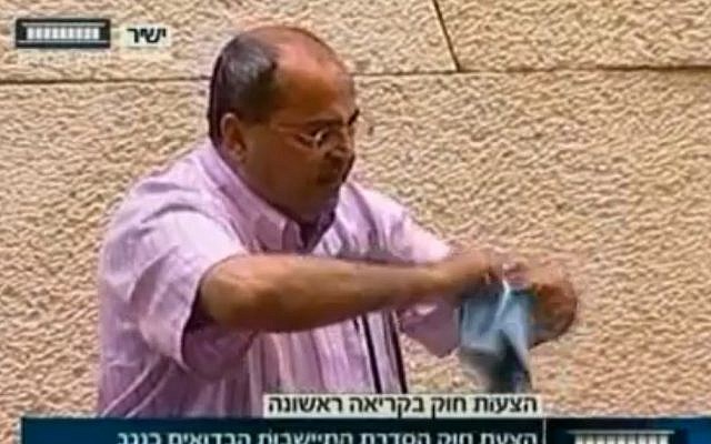 Ahmad Tibi, in the Knesset plenum in June, tears a bill regulating the Bedouin settlements in the Negev. (photo credit: screen capture/Knesset Channel) Ahmad Tibi, in the Knesset plenum in June, tears a bill regulating the Bedouin settlements in the Negev. (photo credit: screen capture/Knesset Channel)
