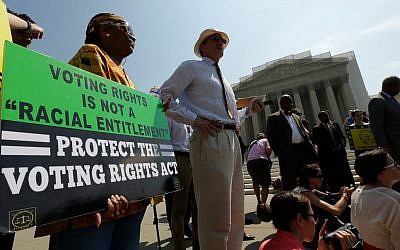 Supporters of the Voting Rights Act waiting outside the US Supreme Court building in Washington after the court struck down a section aimed at protecting minority voters, June 25, 2013. (photo credit: Win McNamee/Getty via JTA)