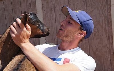 Urban Adamah fellow Nathan Kaufman makes a friend. (Courtesy of Urban Adamah)