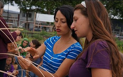 Ariela Ronay-Jinich (left), and Urban Adamah fellow Risa Waldoks at a basket weaving workshop. (photo credit: courtesy of Urban Adamah)