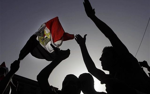Egyptian protesters shout anti-Muslim brotherhood slogans and wave a national flag during a protest against the new judiciary law at the high court in Cairo, Egypt, Monday, June 3, 2013.(photo credit: AP Photo/Amr Nabil) Egyptian protesters shout anti-Muslim brotherhood slogans and wave a national flag during a protest against the new judiciary law at the high court in Cairo, Egypt, Monday, June 3, 2013.(photo credit: AP Photo/Amr Nabil)