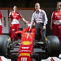 Jerusalem Mayor Nir Barkat with Ferrari technical crew members next to a Ferrari Formula 1 racing car, on display at the Old Jerusalem Train Station, June 9, 2013. (photo credit: Flash 90)