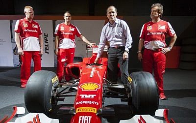 Jerusalem Mayor Nir Barkat with Ferrari technical crew members next to a Ferrari Formula 1 racing car, on display at the Old Jerusalem Train Station, June 9, 2013. (photo credit: Flash 90)