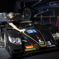A Lotus technical crew member prepares a Lotus LMP2 for display, prior to the opening of a racing car and motorcycle exhibition held at the Old Jerusalem Train Station, on June 9, 2013 (photo credit: Flash90)