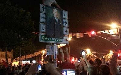 Protesters in Istanbul hold up a poster featuring the founder of the Turkish Republic, Mustafa Kemal Ataturk, considered to be the father of the Turkish nation. (photo credit: Facebook)