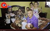The Al Batash family and their 11 children (image capture YouTube)