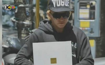 Madonna with a brochure for a Tev Aviv apartment tower. CLICK HERE TO ENLARGE (photo credit: Channel 10 screen capture)