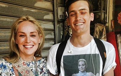 Sharon Stone with a fan in Tel Aviv wearing a T-shirt with a picture from one of her most famous movie scenes. (photo credit: r/pics/Imgur)