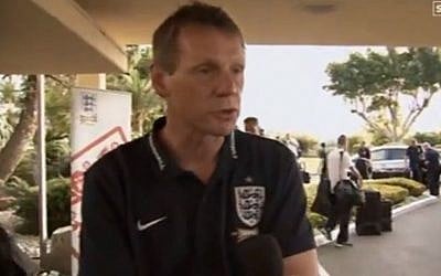 England coach Stuart Pearce speaks at the England team hotel, as players arrive behind him (Youtube screenshot)