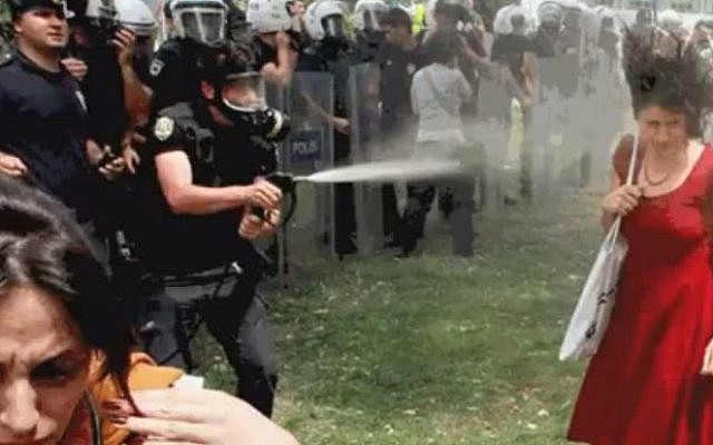 The policeman fires tear gas directly at the woman in the red dress from close range (YouTube screenshot)