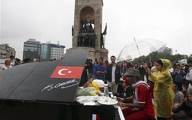 A musician plays the piano under the monument of Mustafa Kemal Ataturk, founder of the modern Turkey, at Taksim Square in Istanbul Friday, June 14, 2013 (photo credit: AP Photo/Thanassis Stavrakis) A musician plays the piano under the monument of Mustafa Kemal Ataturk, founder of the modern Turkey, at Taksim Square in Istanbul Friday, June 14, 2013 (photo credit: AP Photo/Thanassis Stavrakis)