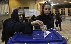 Illustrative photo of two Iranian women casting their ballots during the presidential and municipal councils elections in a polling station in Tehran, Iran, Friday, June 14, 2013 (AP Photo/Vahid Salemi)
