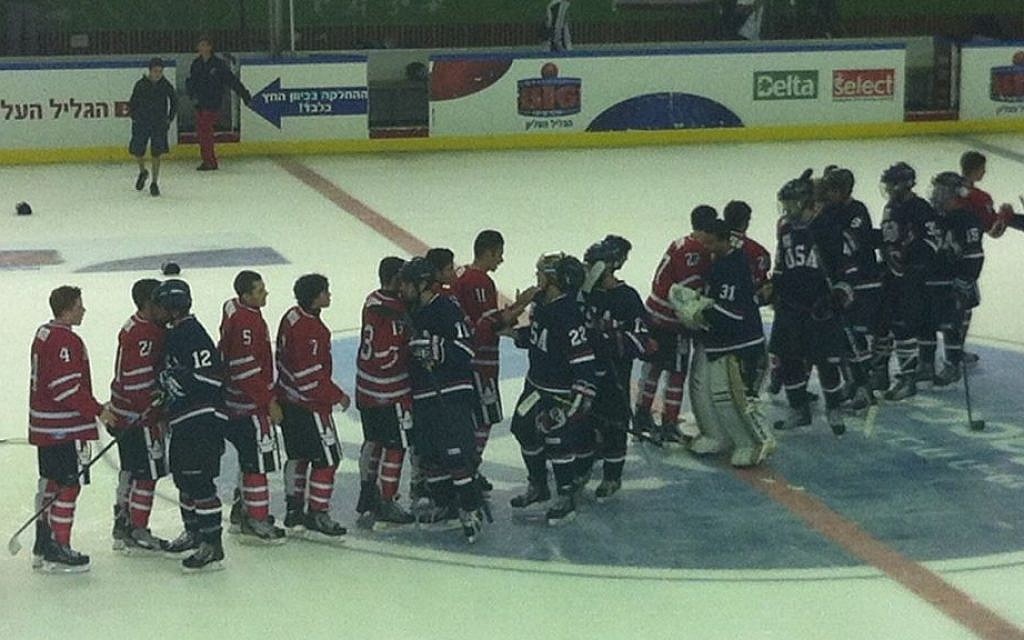 Canadian and US players shake hands after the Maccabiah junior's finals, Friday (photo credit: Aaron Kalman) Canadian and US players shake hands after the Maccabiah junior's finals, Friday (photo credit: Aaron Kalman)