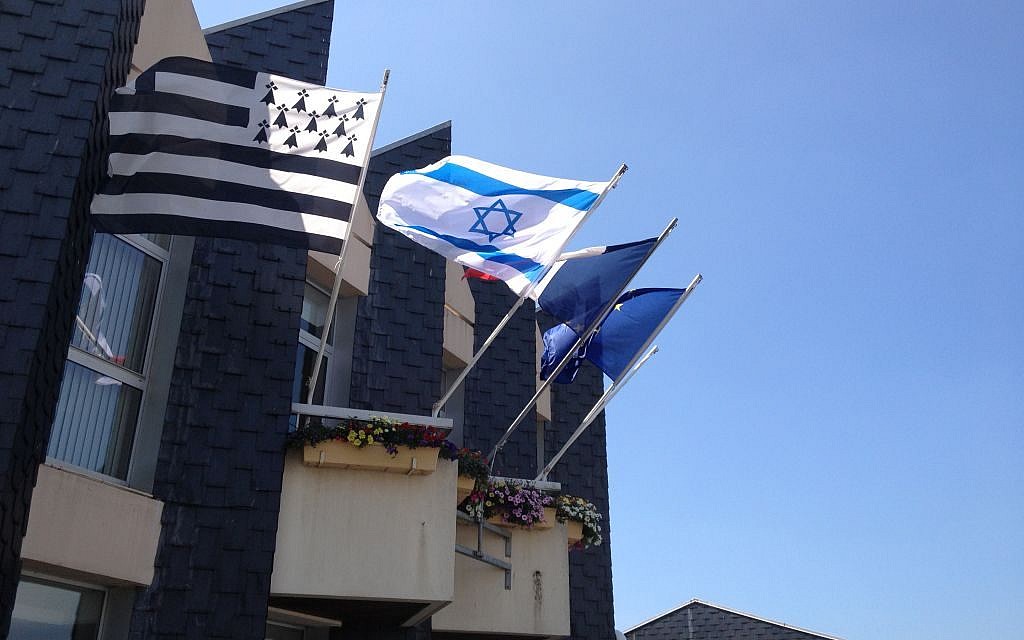 Atop the Douarnenez city hall, the Israeli flag features in between the French and Breton flags (photo credit: Elhanan Miller/Times of Israel)