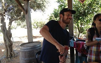 Eli Greenberg, uncorking a bottle at a local winery in Amona (Photo credit: Mitch Ginsburg/ Times of Israel) Eli Greenberg, uncorking a bottle at a local winery in Amona (Photo credit: Mitch Ginsburg/ Times of Israel)