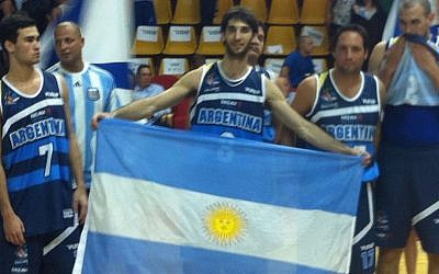 Andres Berman holds the Argentinian flag after finishing in second place (photo credit: Aaron Kalman)