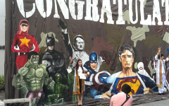 Passersby performing the Nazi salute in front of a mural  depicting Adolf Hitler alongside assorted superheroes in Thailand's Chulalong University (photo credit: Courtesy/Simon Wiesenthal center)