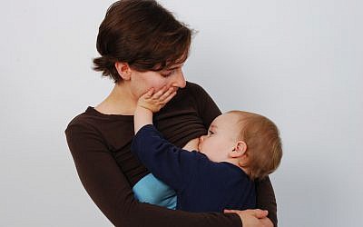 Illustrative photo of a mother breast-feeding her baby. (photo credit: CC BY-A Mothering Touch/Flickr)