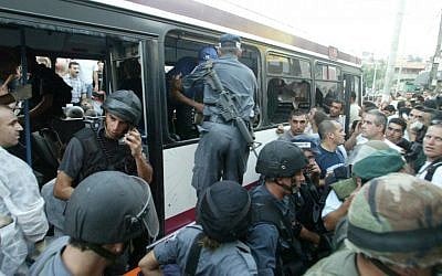 Security forces inspect the bus in which Eden Natan Zada opened fire in 2005, killing four (photo credit: AP/Alex Roskovsky)
