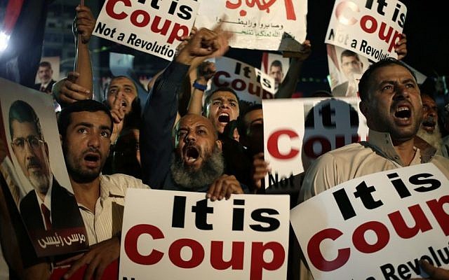 Supporters of Egypt's ousted president Mohammed Morsi chant slogans against members of the country's interim government in Cairo, Egypt, last week. (photo credit: AP/Hassan Ammar) Supporters of Egypt's ousted president Mohammed Morsi chant slogans against members of the country's interim government in Cairo, Egypt, last week. (photo credit: AP/Hassan Ammar)