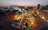 An Egyptian protester waves a national flag as Egyptians gather in Tahrir Square during a demonstration against President Mohammed Morsi in Cairo, Sunday, June 30, 2013. (photo credit: AP/Amr Nabil)