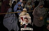 Supporters of Egypt's ousted President Mohammed Morsi pray at Nasr City, where protesters have installed a camp and hold daily rallies, in Cairo, Egypt, Sunday, July 28, 2013 (photo credit: AP/Hassan Ammar)