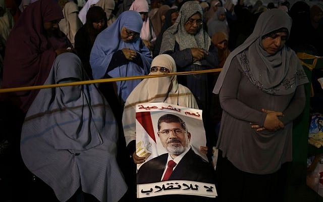 Supporters of Egypt's ousted President Mohammed Morsi pray at Nasr City, where protesters have installed a camp and hold daily rallies, in Cairo, Egypt, Sunday, July 28, 2013 (photo credit: AP/Hassan Ammar) Supporters of Egypt's ousted President Mohammed Morsi pray at Nasr City, where protesters have installed a camp and hold daily rallies, in Cairo, Egypt, Sunday, July 28, 2013 (photo credit: AP/Hassan Ammar)