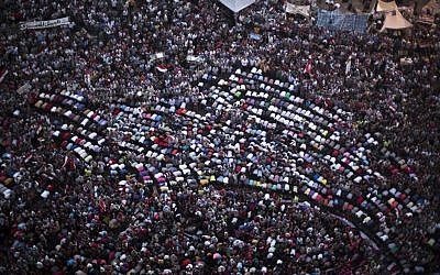 Protesters pray during a demonstration against Egypt's Islamist President Mohammed Morsi in Tahrir Square in Cairo, Monday, July 1 (photo credit: AP/ Manu Brabo)
