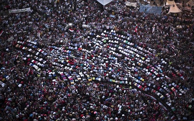 Protesters pray during a demonstration against Egypt's Islamist President Mohammed Morsi in Tahrir Square in Cairo, Monday, July 1 (photo credit: AP/ Manu Brabo) Protesters pray during a demonstration against Egypt's Islamist President Mohammed Morsi in Tahrir Square in Cairo, Monday, July 1 (photo credit: AP/ Manu Brabo)