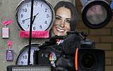 A mask depicting Britain's Duchess of Cambridge and clocks showing New York and London time, placed by members of the media, are seen across from St. Mary's Hospital exclusive Lindo Wing in London, Sunday, July 21, 2013. (photo credit: AP/Lefteris Pitarakis)