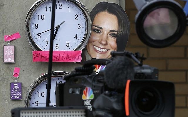 A mask depicting Britain's Duchess of Cambridge and clocks showing New York and London time, placed by members of the media, are seen across from St. Mary's Hospital exclusive Lindo Wing in London, Sunday, July 21, 2013. (photo credit: AP/Lefteris Pitarakis) A mask depicting Britain's Duchess of Cambridge and clocks showing New York and London time, placed by members of the media, are seen across from St. Mary's Hospital exclusive Lindo Wing in London, Sunday, July 21, 2013. (photo credit: AP/Lefteris Pitarakis)