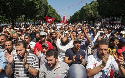 Supporters of the Islamist Ennahda movement march in the streets of Tunis during a demonstration to condemn the assassination of politician Mohammed Brahmi in Tunisia, Friday, July 26, 2013. (photo credit: AP/Amine Landoulsi)