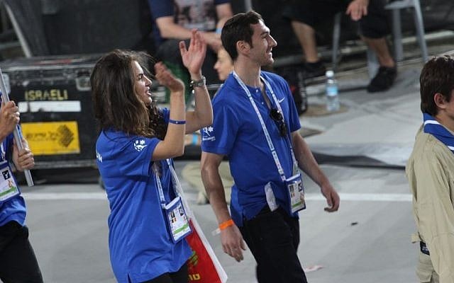 Carole Dwek claps with the Maccabiah crowd as she marches with Belgium delegation at the opening ceremony (photo courtesy Carole Dwek)