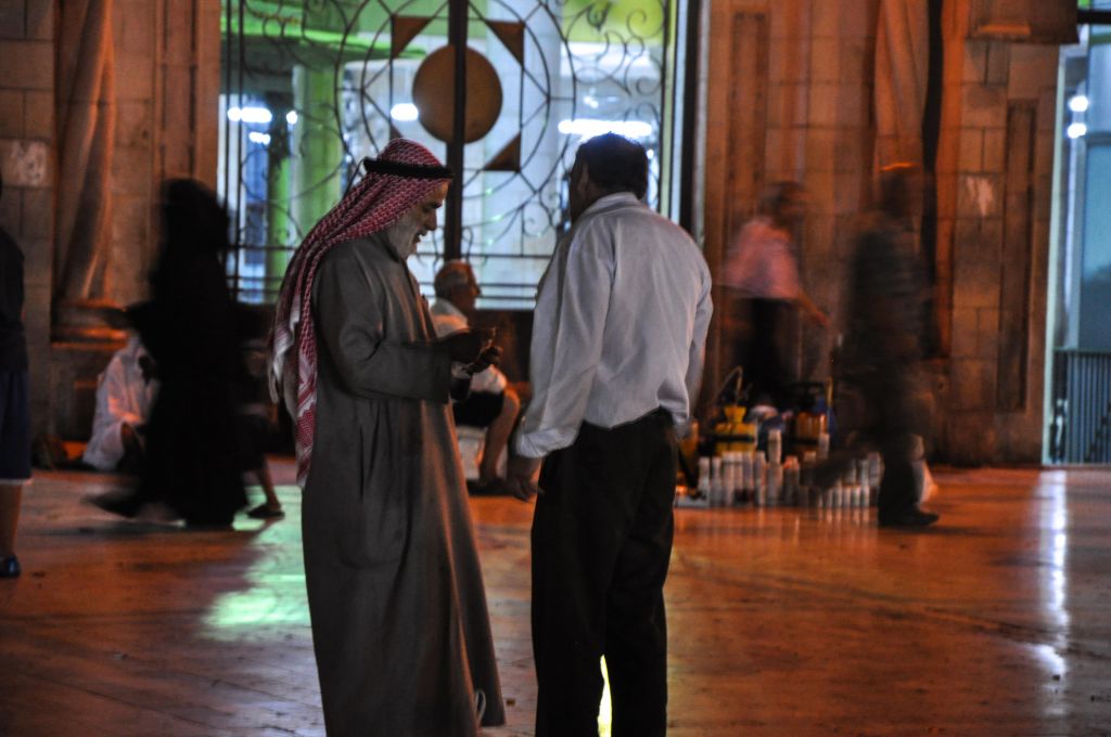 Men chat outside the al-Husseini Mosque in downtown Amman (photo credit: Michal Shmulovich/Times of Israel)