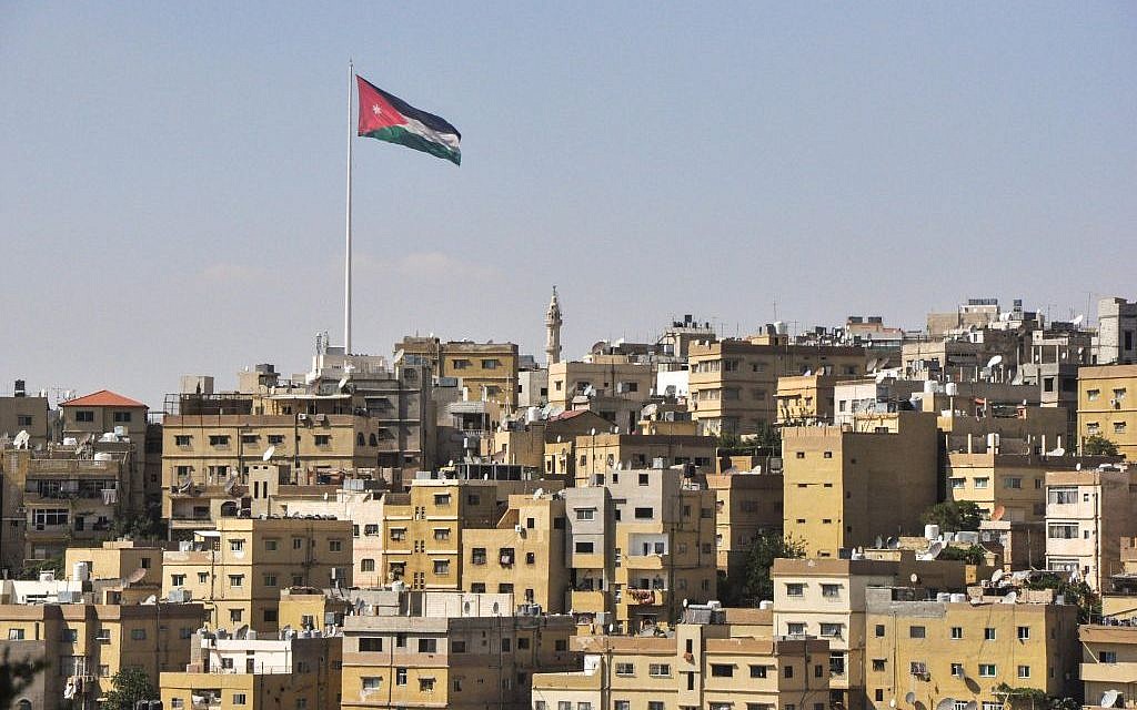 A view of Amman, with the Jordanian flag flying high over the city (photo credit: Michal Shmulovich/Times of Israel)