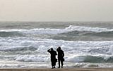 Two ultra-Orthodox men look at the stormy sea on a beach in Ashdod (photo credit: Edi Israel/Flash90)