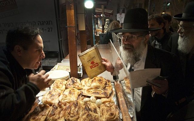 Illustrative photo of a representative of Israel's Chief Rabbinate inspecting a kosher certificate at a food stand in Jerusalem. (Rubin Salvadori/Flash90/File) Illustrative photo of a representative of Israel's Chief Rabbinate inspecting a kosher certificate at a food stand in Jerusalem. (Rubin Salvadori/Flash90/File)