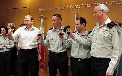 Defense Minister Moshe Ya'alon (left) and chief of the General Staff Lt. Gen. Benny Gantz (right) have unveiled an array of cuts to the defense budget (Photo credit: Ariel Heromni/ Ministry of Defense/ Flash 90)