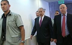 Benjamin Netanyahu, center, walking to a cabinet meeting Sunday, with Gil Shefer at right. (photo credit: Miri Tzahi/ Pool/ Flash90)
