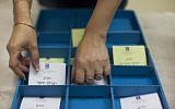FILE — A woman arranging voting slips for the Chief Rabbinate election. (Yonatan Sindel/ Flash90)