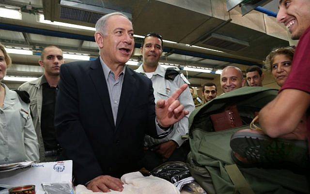 Benjamin Netanyahu speaking to a new recruit at an army base Thursday. (photo credit: Zvika Tishler/Pool/Flash90) Benjamin Netanyahu speaking to a new recruit at an army base Thursday. (photo credit: Zvika Tishler/Pool/Flash90)
