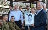 On a visit to new IDF recruits, Prime Minister Netanyahu holds up a picture from when he was drafted. (photo credit: Yossi Zeliger/Flash90)