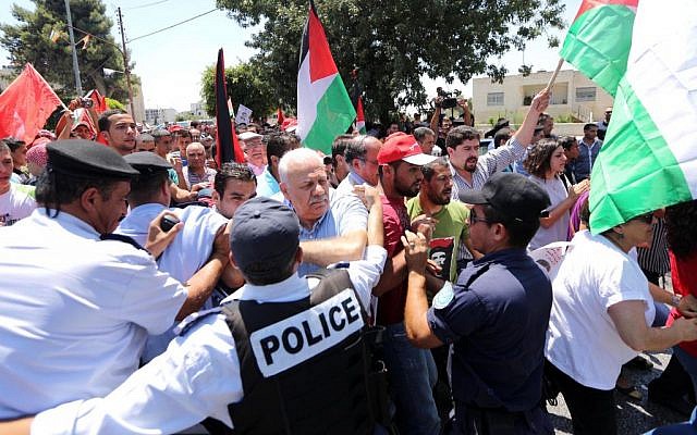 Palestinian riot police clash with protesters demonstrating against upcoming peace talks, in the West Bank city of Ramallah on Sunday. (photo credit: Issam Rimawi/Flash90)