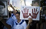 Relatives of Israelis killed in terror attacks demonstrate ahead of the cabinet vote to free 104 Palestinian prisoners, outside the Prime Minister's Office, in Jerusalem in August. The poster reads 'Prisoner release form.' (photo credit: Yonatan Sindel/Flash90)