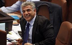 Finance Minister Yair Lapid smiles during the Knesset debate on the 2013-2014 state budget, on July 29, 2013 (photo credit: Flash90)