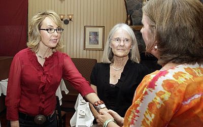 Former Arizona Rep. Gabrielle Giffords greets Jackie Barden, right, mother of a Sandy Hook Elementary School shooting victim Daniel Barden, as local supporter Mary Ann Sosnoff, center, looks on at the Orchard Street Chop Shop in Dover, NH. (photo credit: AP Photo/Mary Schwalm)