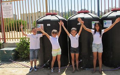 Students at Naot Lonn school in Beersheba show off their school's water recycling system. (photo credit: Debra Kamin/Times of Israel)