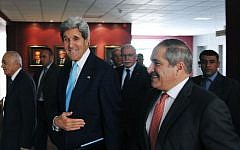 US Secretary of State John Kerry, center, walks with Jordan's Foreign Minister Nasser Judeh at the Ministry of Foreign Affairs in Amman, Jordan, on July 17, 2013. (photo credit: AP/Mandel Ngan)